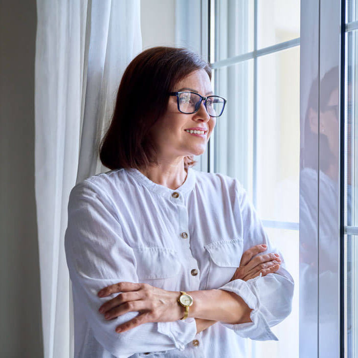 1business-middle-aged-woman-looking-out-the-window